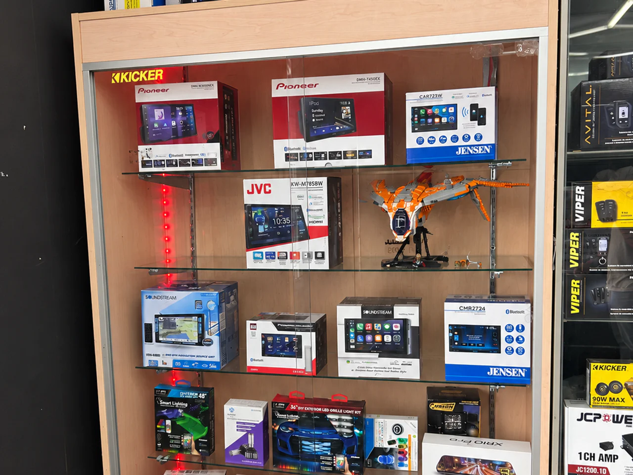 Actual receiver and screen packages in the Campbell showroom's glass display case