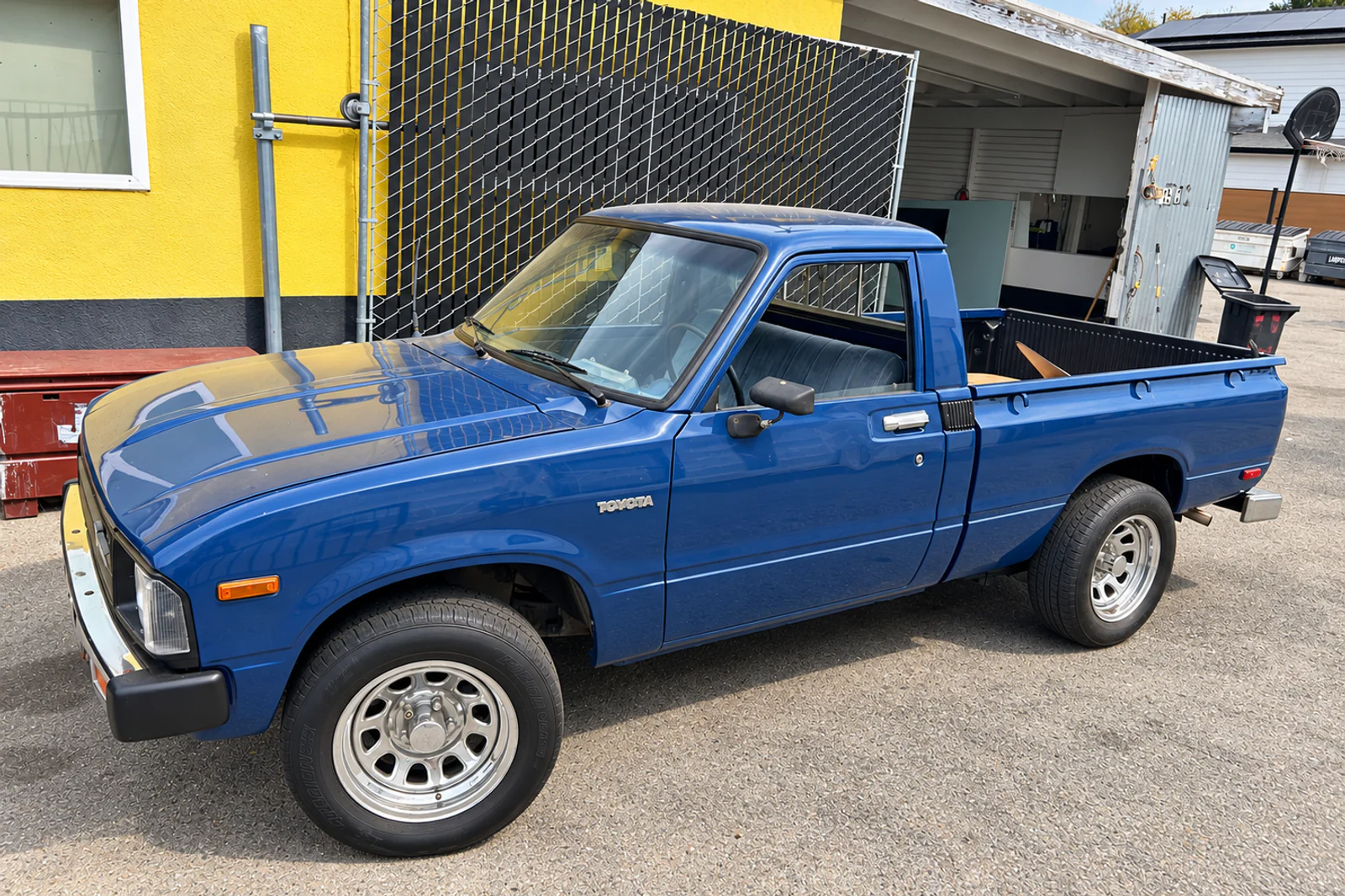 The actual blue Toyota pickup photographed at the Campbell workshop, shown as work in progress
