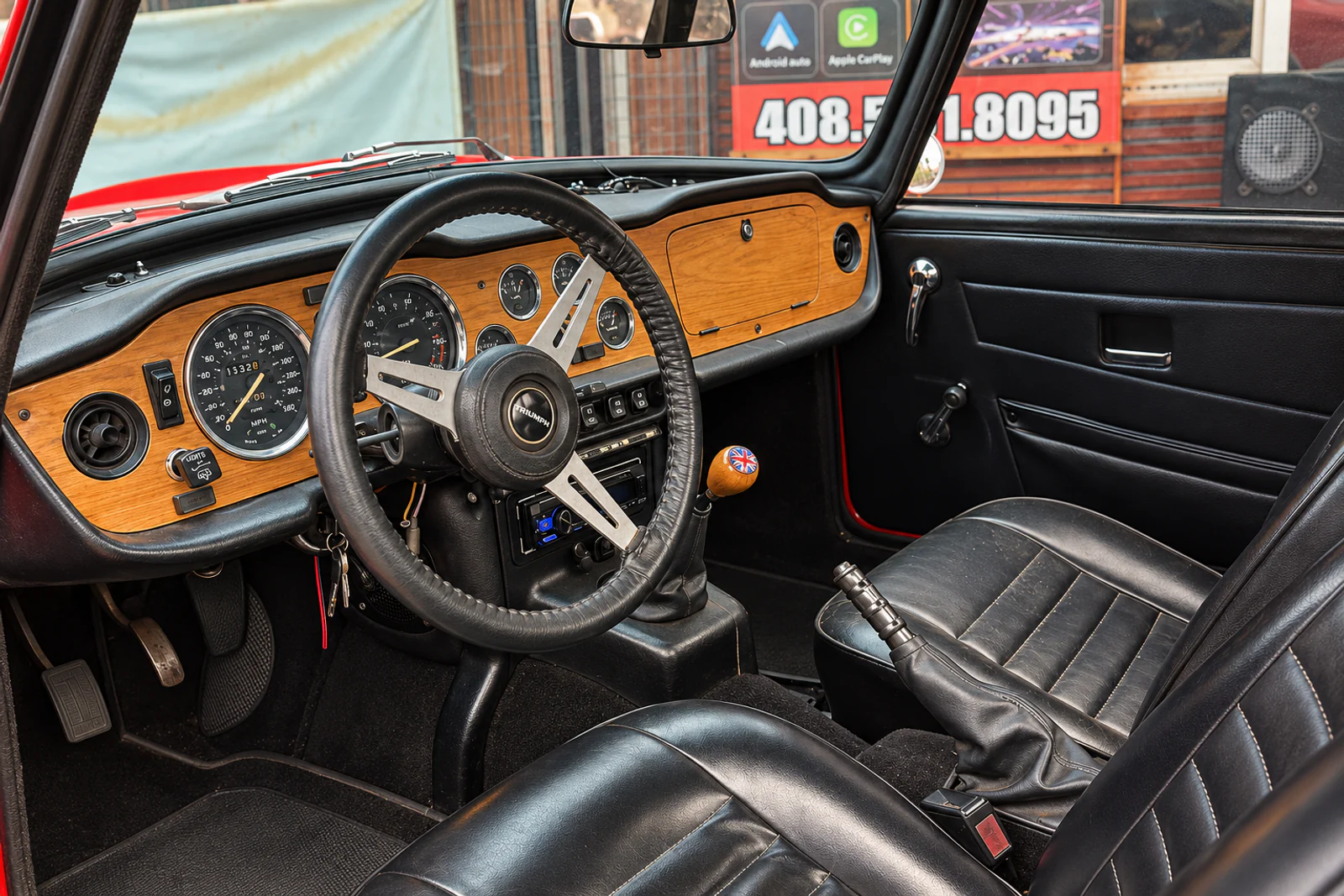 The polished photograph of a real Triumph TR6 interior and its installed stereo at Campbell